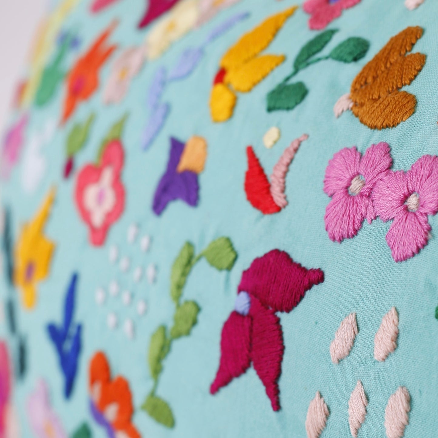 Turquoise hand embroidered cushion