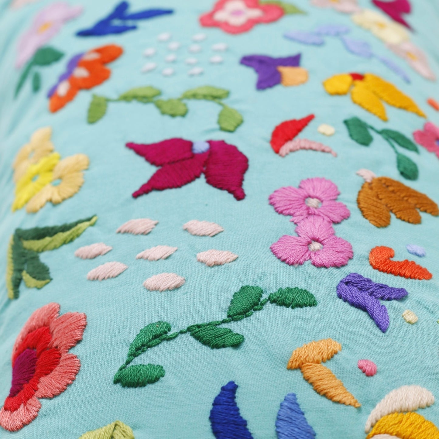 Turquoise hand embroidered cushion