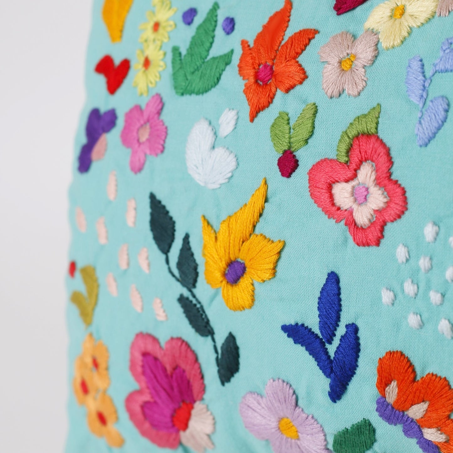 Turquoise hand embroidered cushion