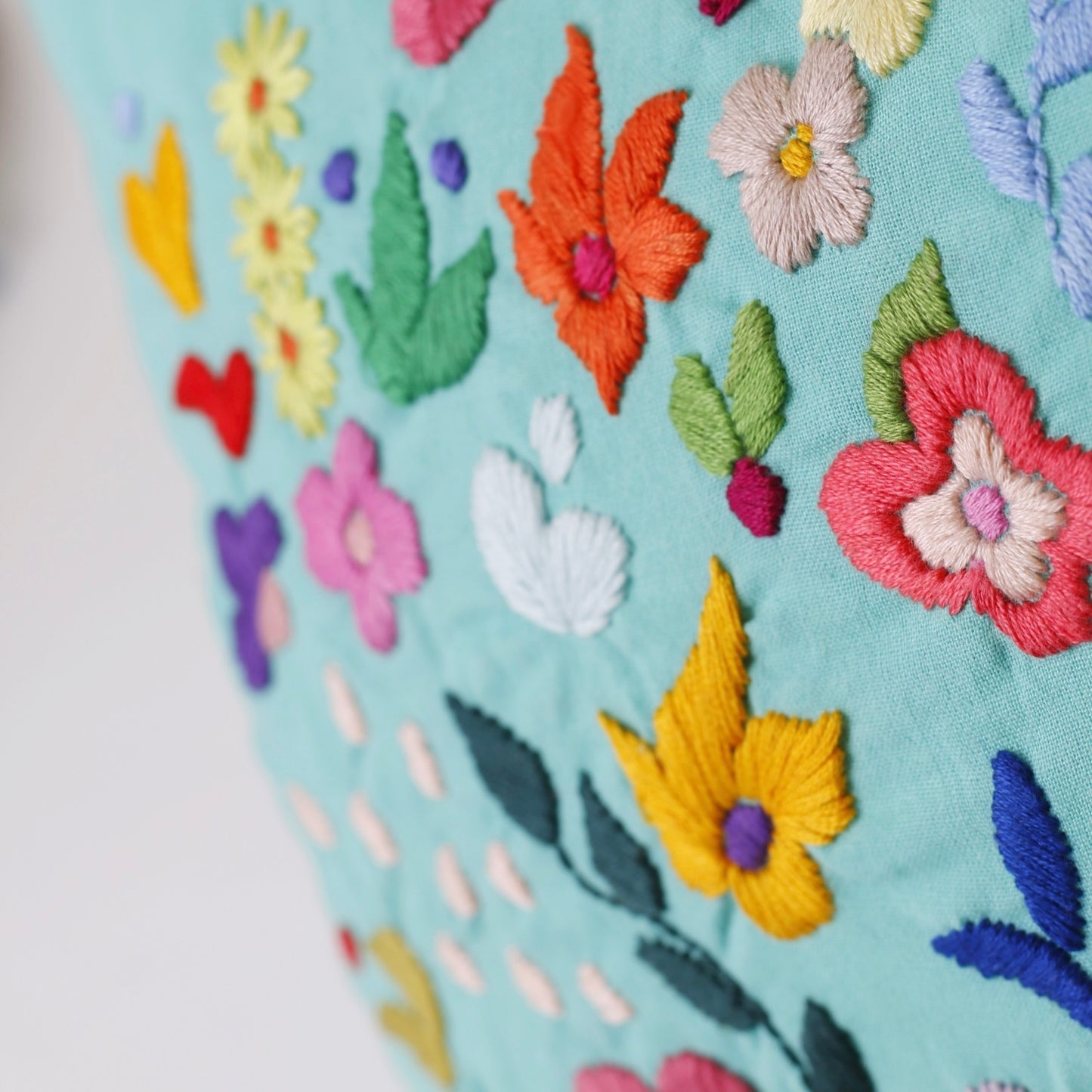 Turquoise hand embroidered cushion